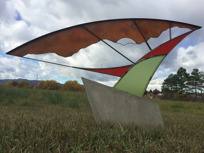 High Country Moon Rising — steel and stone sculpture by Steven Carmer set in a Colorado meadow